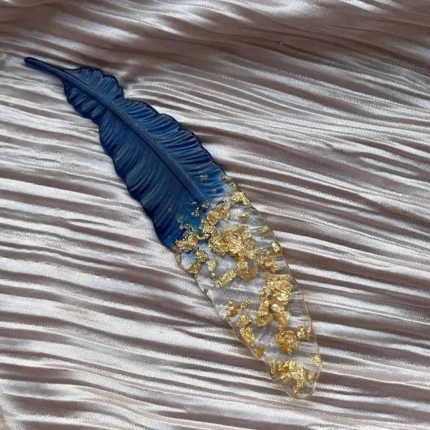 Handmade resin feather bookmark with gold flakes, a perfect gift for book lovers