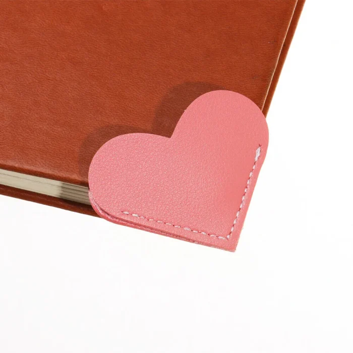 Handmade leather heart bookmark in assorted colors, a stylish and durable page corner marker for books and journals.