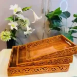 Handmade Pakistani wooden tray with intricate carvings, perfect for serving or decoration.