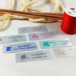 Custom satin sewing labels in 3/4" x 2 1/2" size, perfect for knitting, quilting, and sewing crafts.